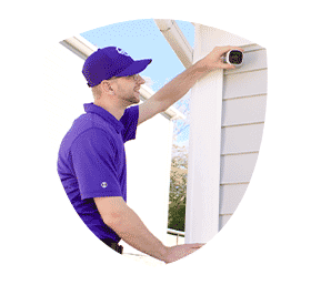 Tech installing outdoor security camera