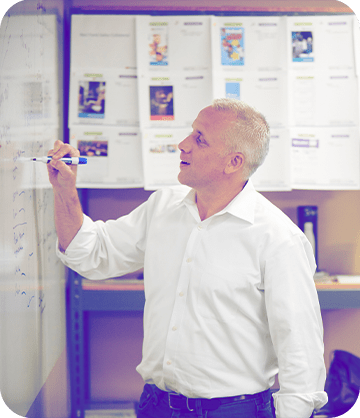 Guardian Protection employee writing on a white board in a conference room