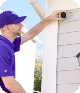 Guardian Protection technician installing an outdoor camera